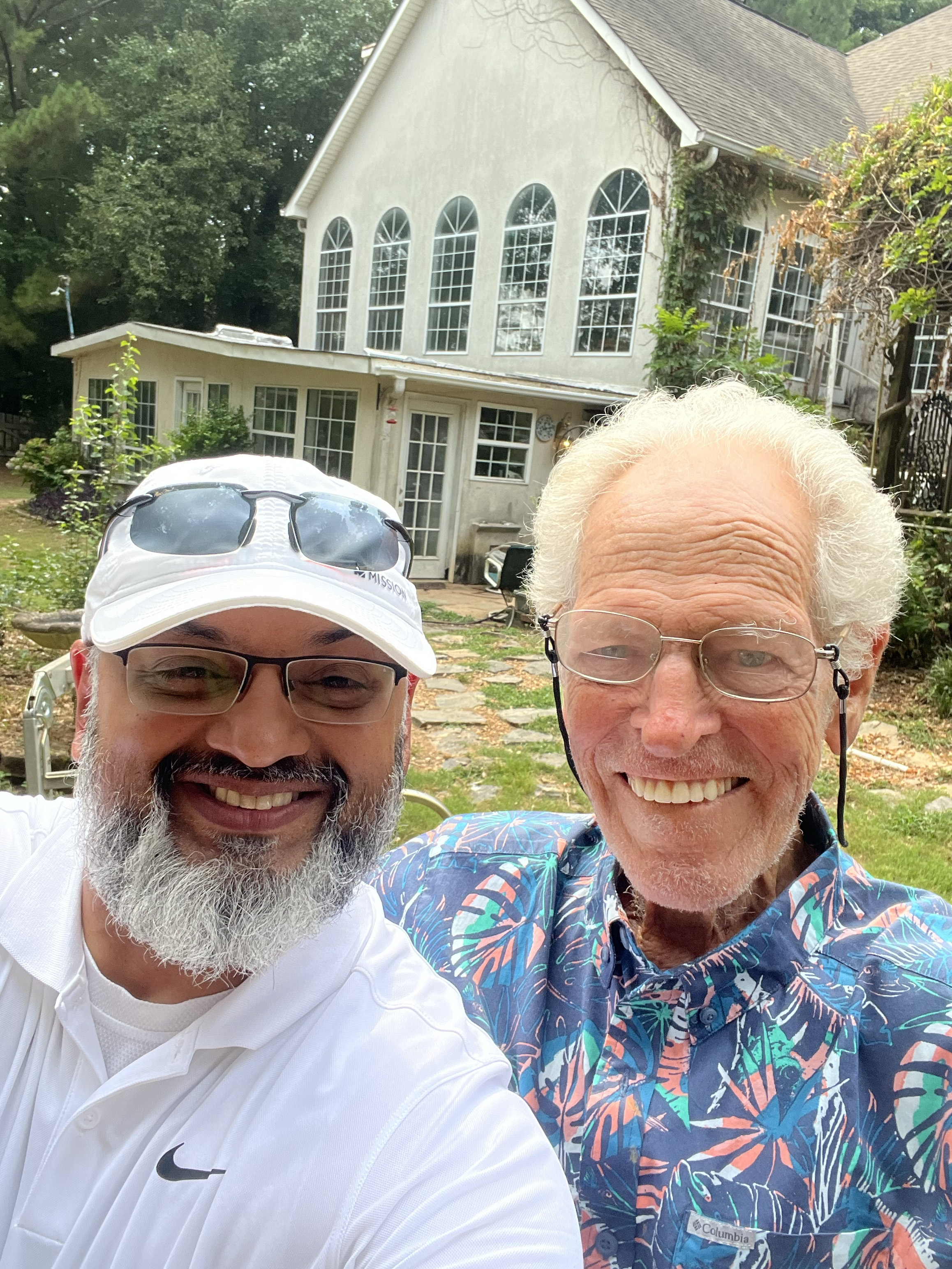Dr. Syed Hasan smiling outdoors with a patient