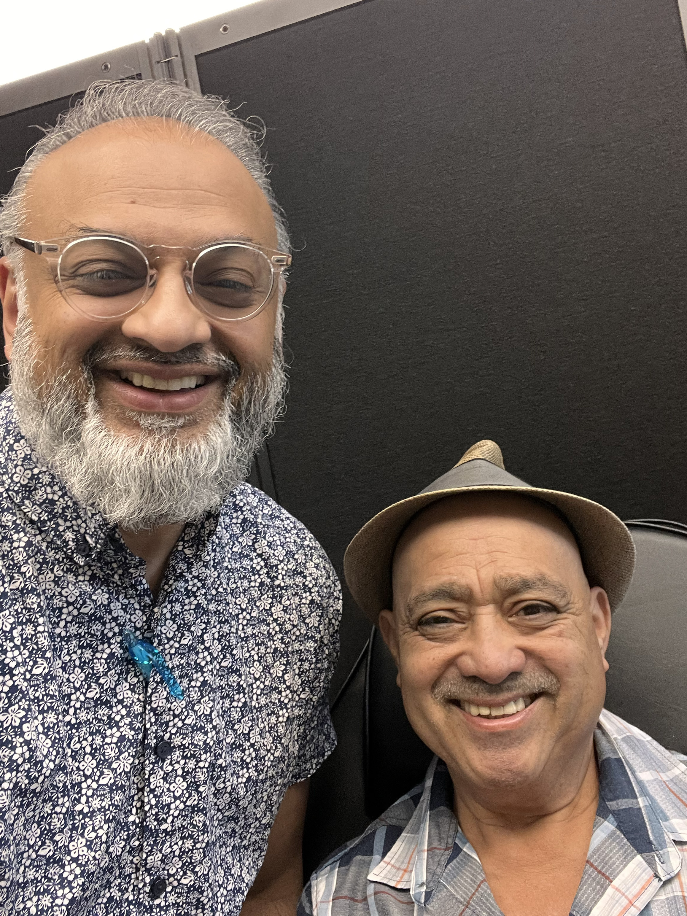 Dr. Syed Hasan smiling with a patient in a clinical setting