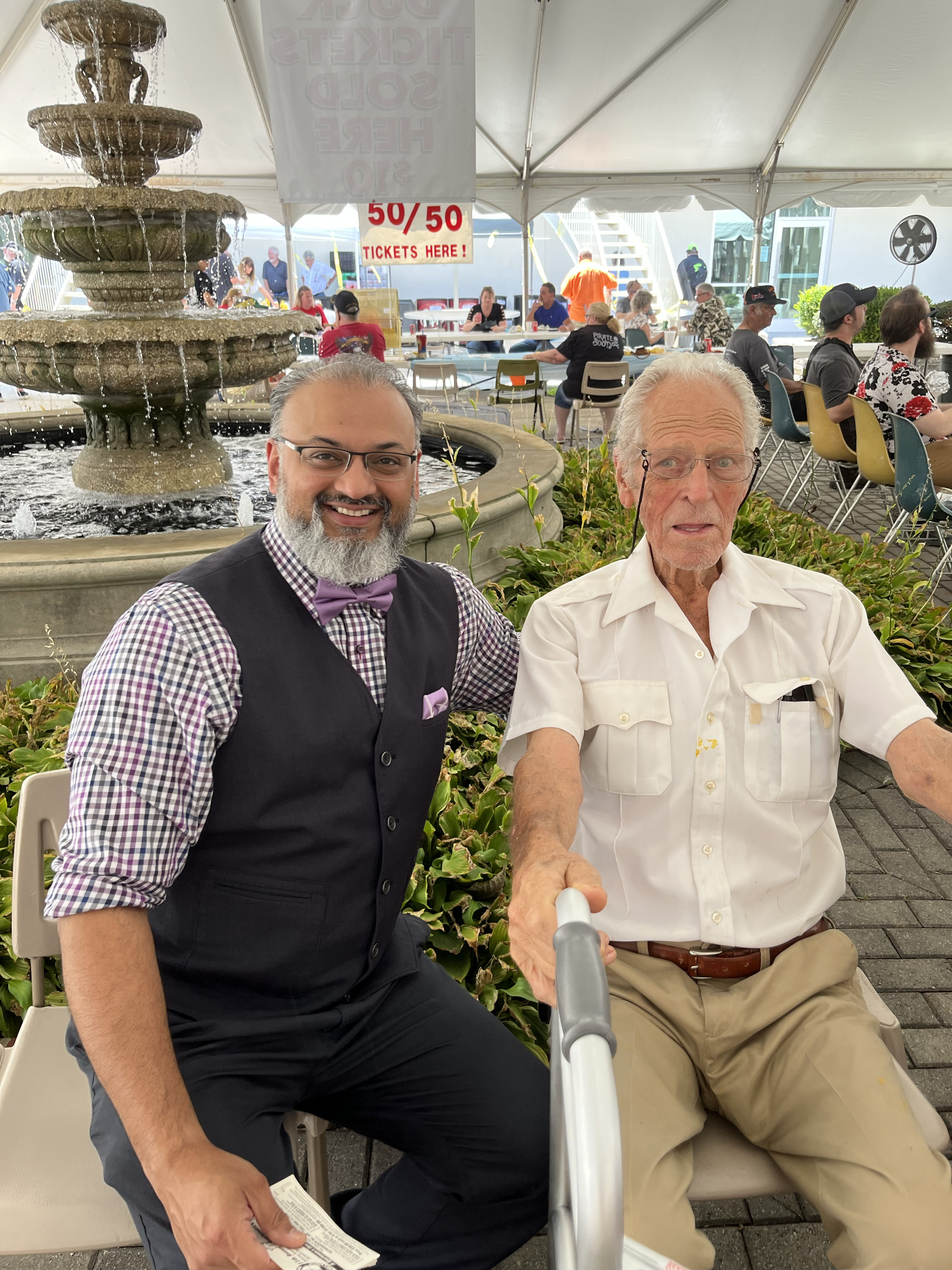 Dr. Syed Hasan with a patient at an outdoor community event